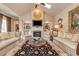 Elegant living room featuring a fireplace, built-in shelving, and designer furnishings at 8025 Georgetown Cir, Suwanee, GA 30024
