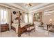 Main bedroom with a four poster bed, tray ceiling, and abundant natural light at 8025 Georgetown Cir, Suwanee, GA 30024