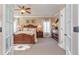 Spacious main bedroom featuring a decorative rug and a ceiling fan at 8025 Georgetown Cir, Suwanee, GA 30024