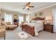 A spacious main bedroom with a cozy sitting area and beautiful furniture at 8025 Georgetown Cir, Suwanee, GA 30024