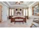 Main bedroom with a four-poster bed, tray ceiling and an ensuite bathroom at 8025 Georgetown Cir, Suwanee, GA 30024