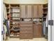 Spacious walk-in closet with custom shelving and ample storage for shoes and clothing at 8025 Georgetown Cir, Suwanee, GA 30024