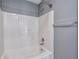 Clean bathroom features a shower and bathtub combination with white tiling and modern fixtures at 5362 Hickory Nw Knl, Norcross, GA 30071
