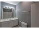 Bathroom featuring a white vanity, tile walls, and framed mirror at 5362 Hickory Nw Knl, Norcross, GA 30071