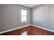 Bedroom boasts hardwood floors and a window overlooking a yard at 5362 Hickory Nw Knl, Norcross, GA 30071