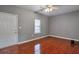 A cozy bedroom with hardwood floors and great natural light from the large windows at 5362 Hickory Nw Knl, Norcross, GA 30071