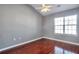 A vaulted ceiling and large window brighten this bedroom with a ceiling fan and hardwood flooring at 5362 Hickory Nw Knl, Norcross, GA 30071