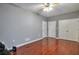 Spacious bedroom featuring gleaming hardwood floors, a ceiling fan, and ample closet space at 5362 Hickory Nw Knl, Norcross, GA 30071