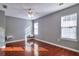 A well-lit bedroom features hardwood floors, neutral walls, and a ceiling fan for added comfort at 5362 Hickory Nw Knl, Norcross, GA 30071
