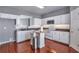Efficient galley kitchen with white cabinets, stainless steel appliances, and a serving hatch at 5362 Hickory Nw Knl, Norcross, GA 30071