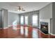 Cozy living room features a ceiling fan, fireplace, hardwood floors, and access to outside at 5362 Hickory Nw Knl, Norcross, GA 30071