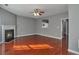 Bright living room features a fireplace, ceiling fan, and lovely wood floors at 5362 Hickory Nw Knl, Norcross, GA 30071