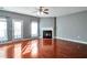Sun-filled living room with fireplace, and hardwood floors; door leads to patio or balcony at 5362 Hickory Nw Knl, Norcross, GA 30071