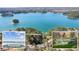 Expansive aerial view of a lakeside property featuring a house, private dock, and serene lake surrounded by lush trees at 6475 Holland Dr, Cumming, GA 30041