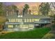 Stunning back exterior featuring a multi-level deck, ample windows, gray siding, and a lush green lawn at 6475 Holland Dr, Cumming, GA 30041