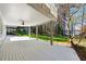 Spacious covered back porch with scenic views of the wooded backyard and lake at 6475 Holland Dr, Cumming, GA 30041