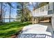 A manicured lawn with a lake view, and a back porch overlooking the lake at 6475 Holland Dr, Cumming, GA 30041