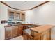 Home bar featuring wood cabinetry, granite countertops, and a sink at 6475 Holland Dr, Cumming, GA 30041