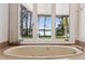 A relaxing view from the bathtub showing the lake and lush green lawn at 6475 Holland Dr, Cumming, GA 30041