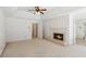 A spacious bedroom with a fireplace, ceiling fan, and carpeted flooring at 6475 Holland Dr, Cumming, GA 30041