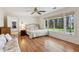 Bright bedroom features wood floors, a large window with outdoor views, and a ceiling fan at 6475 Holland Dr, Cumming, GA 30041
