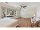 A bedroom boasts hardwood floors, large windows, and bright lighting with white walls at 6475 Holland Dr, Cumming, GA 30041