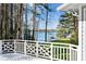 Exterior deck view showcasing white railings and scenic views of the surrounding lake at 6475 Holland Dr, Cumming, GA 30041
