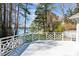Exterior deck view showcasing white railings and scenic views of the surrounding lake at 6475 Holland Dr, Cumming, GA 30041