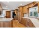 Kitchen with wood cabinets, stainless steel appliances, and view to outdoors at 6475 Holland Dr, Cumming, GA 30041