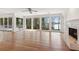 Bright living room with hardwood floors, lake views from the many windows, and fireplace at 6475 Holland Dr, Cumming, GA 30041