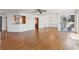 Open living room with hardwood floors, white trim, and views to the kitchen area at 6475 Holland Dr, Cumming, GA 30041