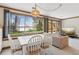 Open-concept living and dining space with a large window view of the outdoor lake at 6475 Holland Dr, Cumming, GA 30041