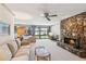 Spacious living room featuring a fireplace, lake view, and neutral decor at 6475 Holland Dr, Cumming, GA 30041
