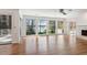 Bright living room featuring hardwood floors, fireplace, and sliding doors to outdoor deck at 6475 Holland Dr, Cumming, GA 30041