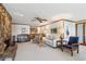 Inviting living room with a stone fireplace and a full bar with wood cabinetry at 6475 Holland Dr, Cumming, GA 30041