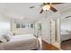Bright main bedroom featuring a lake view, hardwood floors, and ensuite bathroom at 6475 Holland Dr, Cumming, GA 30041
