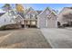 Charming two-story home featuring a well-manicured lawn, stone accents, and a two-car garage at 86 Templeton Ln, Villa Rica, GA 30180