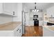 Modern kitchen with stainless steel appliances, white cabinets, and hardwood floors at 86 Templeton Ln, Villa Rica, GA 30180