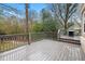 Spacious outdoor deck with a grill overlooking the wooded backyard at 2413 Drew Valley Rd, Brookhaven, GA 30319