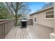 Spacious outdoor deck with a grill overlooking the tree lined back yard at 2413 Drew Valley Rd, Brookhaven, GA 30319