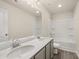 Bathroom featuring double vanity sinks, modern fixtures, and a shower-tub combo at 1084 Georgian Point Dr, Lawrenceville, GA 30045