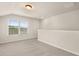Upstairs loft space featuring carpeted floors and a window at 1084 Georgian Point Dr, Lawrenceville, GA 30045