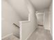 Upstairs hallway featuring carpeted floors, a light-colored wall, and white trim at 1084 Georgian Point Dr, Lawrenceville, GA 30045