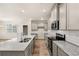 Modern kitchen with granite countertops, stainless steel appliances, and gray cabinets at 1084 Georgian Point Dr, Lawrenceville, GA 30045
