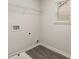 Functional laundry room featuring a wire shelf, washer hookups, and a window for natural light at 1084 Georgian Point Dr, Lawrenceville, GA 30045