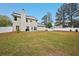 Expansive backyard with a well-maintained lawn, fenced perimeter, and view of the home, perfect for outdoor activities at 12947 Dunand Blvd, Hampton, GA 30228