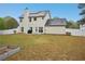 Spacious backyard with privacy fence and a view of the home's rear facade, offering an outdoor retreat at 12947 Dunand Blvd, Hampton, GA 30228