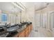 Bathroom features a unique glass vessel sink on a granite countertop with a soaking tub in the background at 12947 Dunand Blvd, Hampton, GA 30228