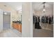 A pass through bathroom connects a walk-in closet with shelving and rods to a vanity and sink area at 12947 Dunand Blvd, Hampton, GA 30228