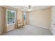 Bright bedroom featuring neutral tones, with a large window with curtains and plush carpeting at 12947 Dunand Blvd, Hampton, GA 30228